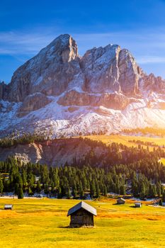 Stunning view of Peitlerkofel mountain from Passo delle Erbe in Dolomites, Italy. View of Sass de Putia (Peitlerkofel) at Passo delle Erbe, with wooden farm houses, Dolomites, South Tyrol, Italy.