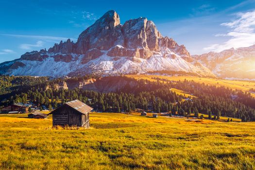 Stunning view of Peitlerkofel mountain from Passo delle Erbe in Dolomites, Italy. View of Sass de Putia (Peitlerkofel) at Passo delle Erbe, with wooden farm houses, Dolomites, South Tyrol, Italy.