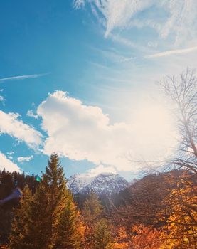 Beautiful nature of European Alps, landscape view of alpine mountains, lake and village in autumn season, travel and destination scenery