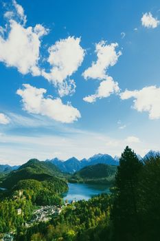 Beautiful nature of European Alps, landscape view of alpine mountains, lake and village in spring season, travel and destination scenery