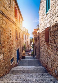 Beautiful street with flowers in the Hvar town, Hvar island, Dalmatia, Croatia. Old Mediterranean street, Hvar town. Old Adriatic town Hvar. Medieval street. Popular touristic destination of Croatia.