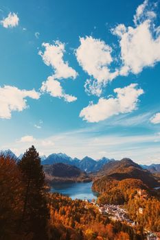 Beautiful nature of European Alps, landscape view of alpine mountains, lake and village in autumn season, travel and destination scenery