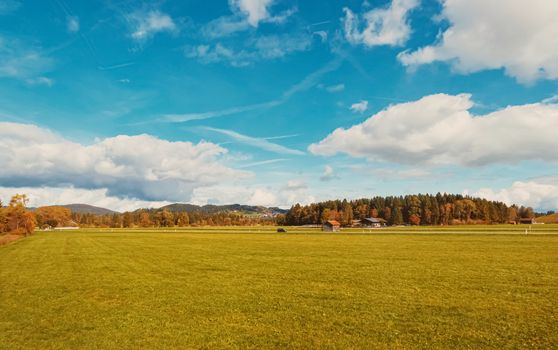 Beautiful nature of European Alps, landscape view of alpine mountains, lake and village in autumn season, travel and destination scenery