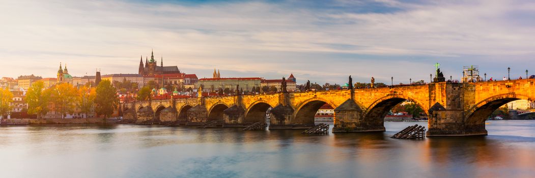 Charles Bridge in Prague in Czechia. Prague, Czech Republic. Charles Bridge (Karluv Most) and Old Town Tower. Vltava River and Charles Bridge. Concept of world travel, sightseeing and tourism.