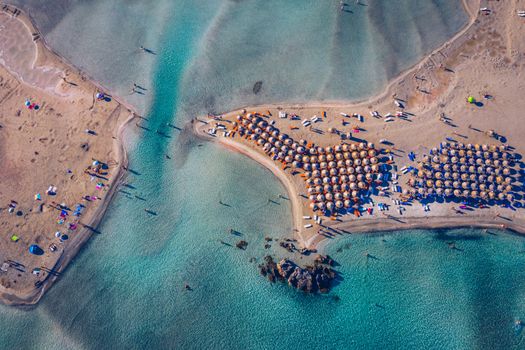 Aerial drone shot of beautiful turquoise beach with pink sand Elafonissi, Crete, Greece. Best beaches of Mediterranean, Elafonissi beach, Crete, Greece. Famous Elafonisi beach on Greece island, Crete.