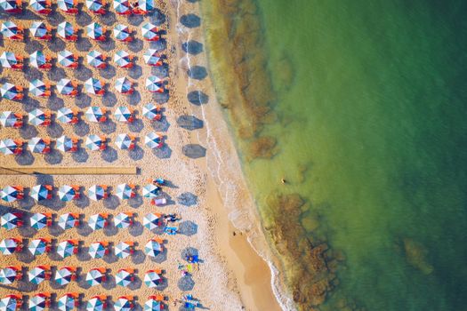 Aerial drone top view of turquoise organised beach forming a small heart shaped lagoon and mountainous seascape of Stavros, Chania, Crete island, Greece. Picturesque Stavros beach at Crete, Greece.