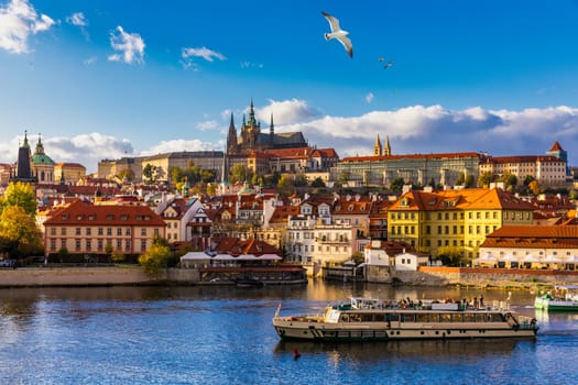 Prague Castle, Charles Bridge and boats on the Vltava river. View of Hradcany Prague Castle, Charles Bridge and a boats on the Vltava river in the capital of the Czechia. Boat cruise on Vltava river.