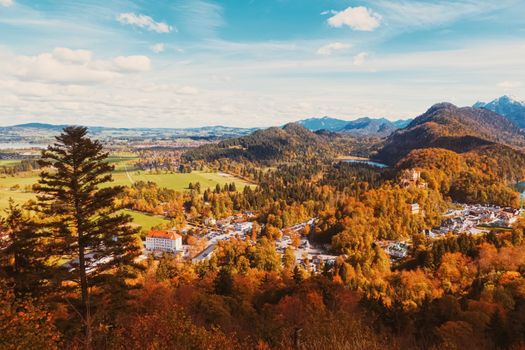 Beautiful nature of European Alps, landscape view of alpine mountains, lake and village in autumn season, travel and destination scenery