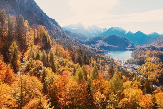 Beautiful nature of European Alps, landscape view of alpine mountains, lake and village in autumn season, travel and destination scenery