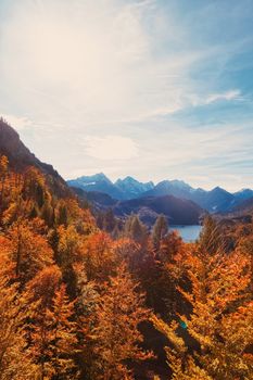 Beautiful nature of European Alps, landscape view of alpine mountains, lake and village in autumn season, travel and destination scenery