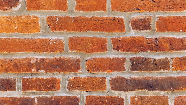 Old brick wall, old texture of red stone blocks closeup. The texture of the brick. Background of empty brick basement wall. Grunge red brick wall background with copy space.