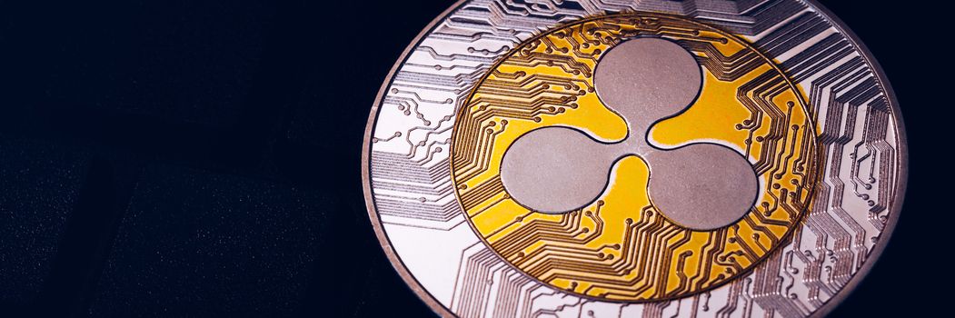 Ripple cryptocurrency (crypto currency). Silver Ripple coin with gold Ripple symbol. Ripple (XRP) cryptocurrency.