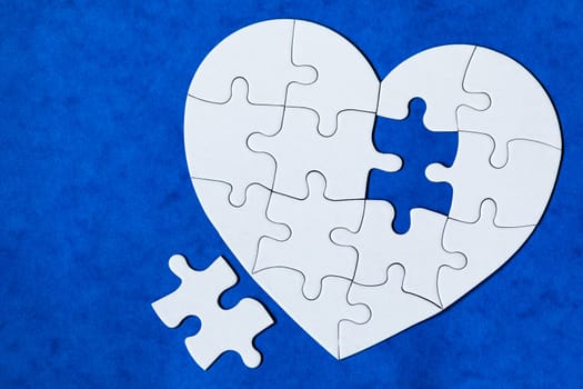 Heart object made of puzzle pieces. Make complete heart. Jigsaw puzzle pieces in form of heart. Happy Valentines Day, greeting card template. Heart jigsaw puzzle.