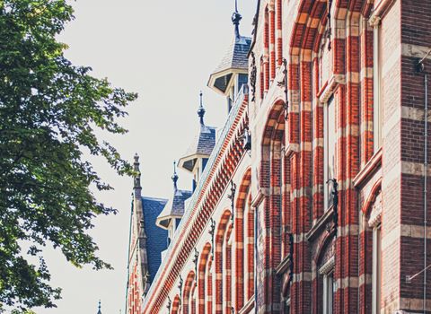 Main downtown street in the city center of Amsterdam in Netherlands on sunny day