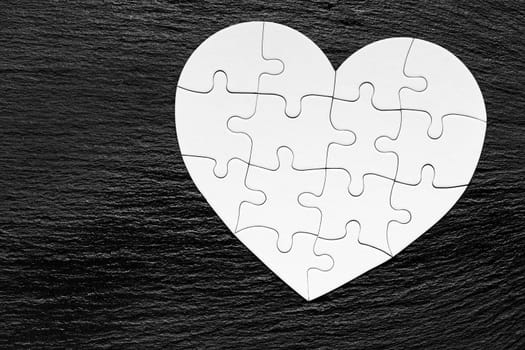 Heart object made of puzzle pieces. Make complete heart. Jigsaw puzzle pieces in form of heart. Happy Valentines Day, greeting card template. Heart jigsaw puzzle.