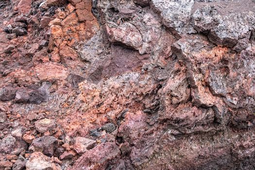 Leilani Estate, Hawaii, USA. - January 14, 2020: 2018 Kilauea volcano eruption hardened black lava field. Closeup of inner red and brown pieces of layer.