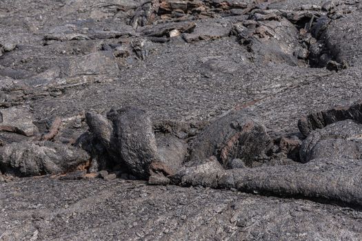 Leilani Estate, Hawaii, USA. - January 14, 2020: 2018 Kilauea volcano eruption hardened black lava field. Closeup of upper crust wave-like fold.