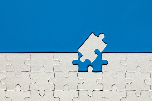 Closeup of jigsaw puzzle isolated. Missing jigsaw puzzle piece, business concept for completing the puzzle piece. Group of puzzle and a puzzle piece. Teamwork concept. Think difference concept. 