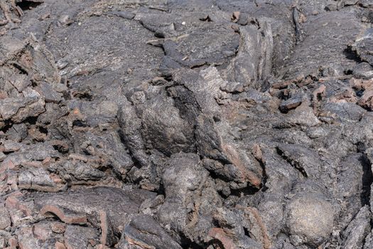 Leilani Estate, Hawaii, USA. - January 14, 2020: 2018 Kilauea volcano eruption hardened black lava field. Closeup of upper crust dough-like fold.