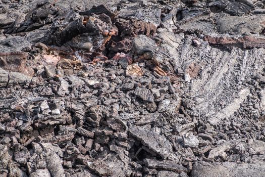 Leilani Estate, Hawaii, USA. - January 14, 2020: 2018 Kilauea volcano eruption hardened black lava field. Closeup of upper crust broken tube-like structures and folds.