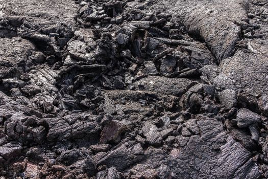 Leilani Estate, Hawaii, USA. - January 14, 2020: 2018 Kilauea volcano eruption hardened black lava field. Closeup of upper crust folds.