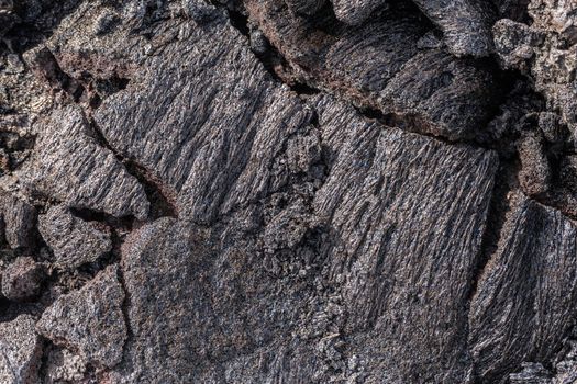 Leilani Estate, Hawaii, USA. - January 14, 2020: 2018 Kilauea volcano eruption hardened black lava field. Closeup of cracked crust.