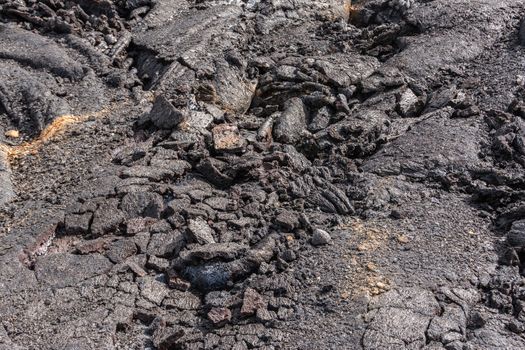 Leilani Estate, Hawaii, USA. - January 14, 2020: 2018 Kilauea volcano eruption hardened black lava field. Closeup of cracked folds of crust.