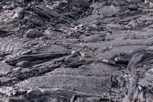 Leilani Estate, Hawaii, USA. - January 14, 2020: 2018 Kilauea volcano eruption hardened black lava field. Closeup of liquid like layers of crust.