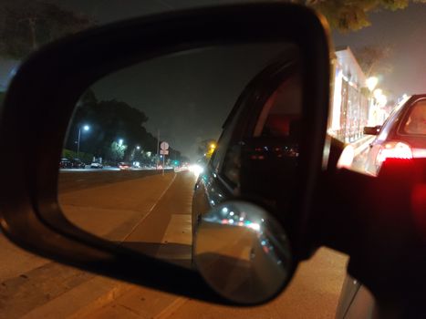 a car mirror showing upcoming cars.