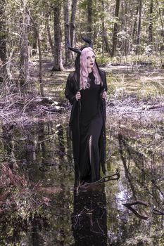 A gorgeous gothic model acts in a forest environment