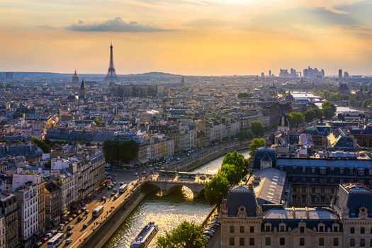 Panoramic aerial view of Paris, Eiffel Tower and La Defense business district. Aerial view of Paris at sunset. Panoramic view of Paris skyline with Eiffel Tower and La Defense. Paris, France. 