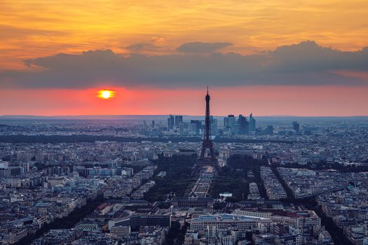 View of Paris with Eiffel Tower from Montparnasse building. Eiffel tower view from Montparnasse at sunset, view of the Eiffel Tower and La Defense district in Paris, France.