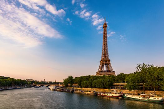 Paris Eiffel Tower and river Seine at sunset in Paris, France. Eiffel Tower is one of the most iconic landmarks of Paris. Eiffel tower in summer, Paris, France. The Eiffel Tower in Paris, France.