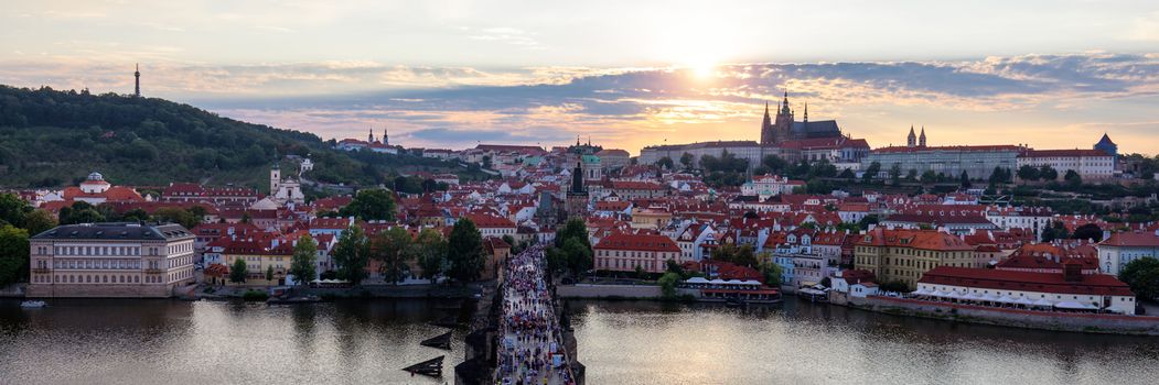 Scenic summer aerial panorama of the Old Town architecture in Prague, Czech Republic. Red roof tiles panorama of Prague old town.  Prague Old Town Square houses with traditional red roofs. Czechia.