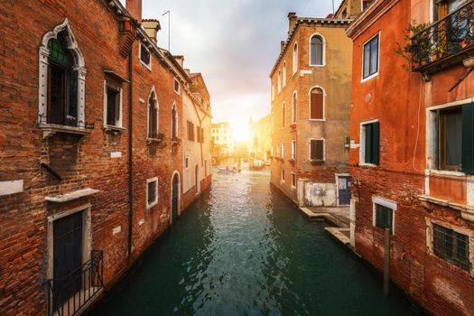 View of the street canal in Venice, Italy. Colorful facades of old Venice houses. Venice is a popular tourist destination of Europe. Venice, Italy.