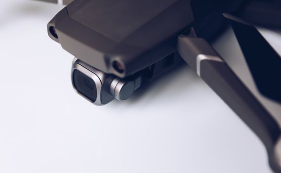 New modern drone on display on white background. Drone quadcopter with digital camera.