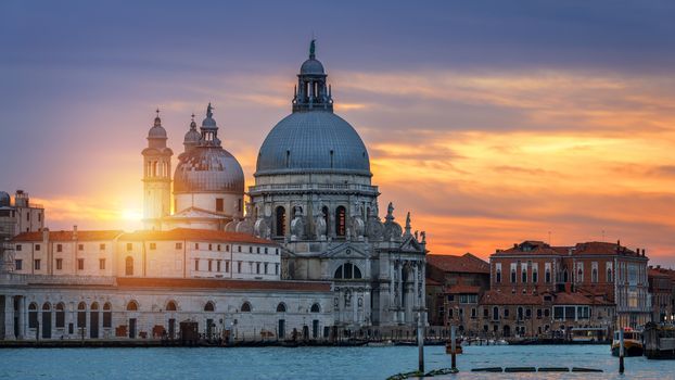 View of the street canal in Venice, Italy. Colorful facades of old Venice houses. Venice is a popular tourist destination of Europe. Venice, Italy.