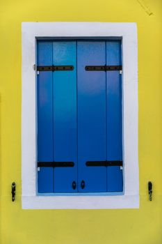 Colorful window of a house on the Venetian island of Burano, Venice. Facade of the houses of Burano close-up. Venice, Italy.
