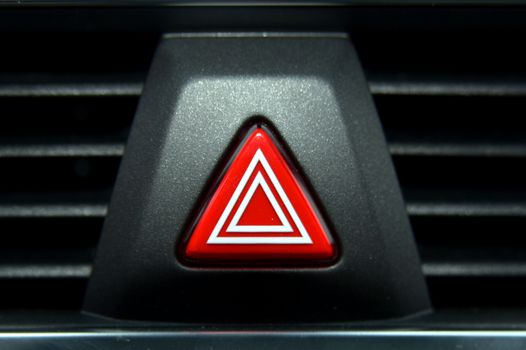 A switch for the hazard lights in the car