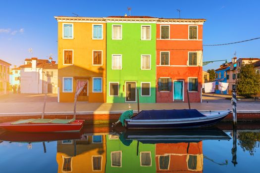 Street with colorful buildings in Burano island, Venice, Italy. Architecture and landmarks of Burano, Venice postcard. Scenic canal and colorful architecture in Burano island near Venice, Italy