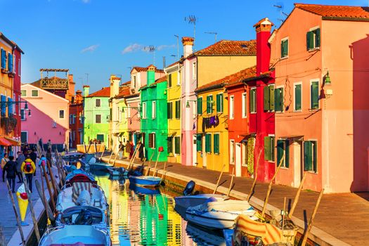Street with colorful buildings in Burano island, Venice, Italy. Architecture and landmarks of Burano, Venice postcard. Scenic canal and colorful architecture in Burano island near Venice, Italy