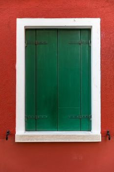 Colorful window of a house on the Venetian island of Burano, Venice. Facade of the houses of Burano close-up. Venice, Italy.