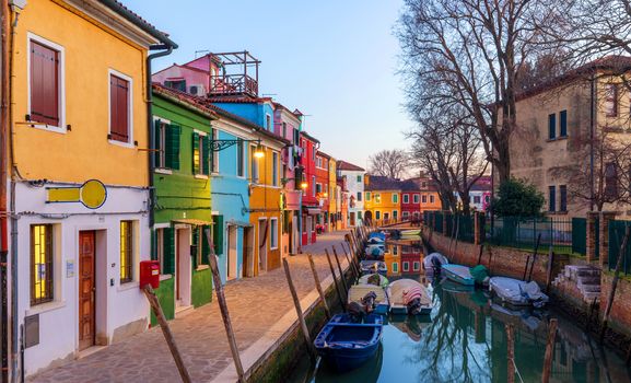 Lovely house facade and colorful walls in Burano, Venice. Burano island canal, colorful houses and boats, Venice landmark, Italy. Europe