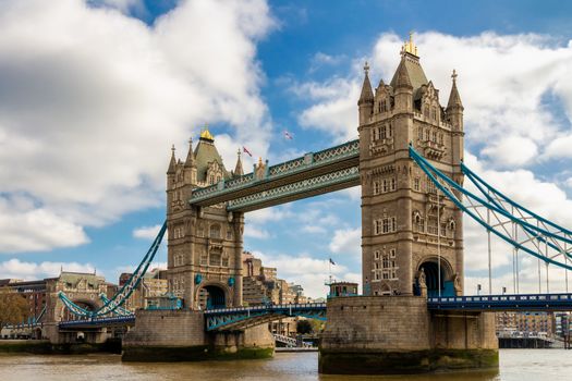 Tower Bridge with reflections at sunset in London, UK.