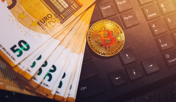 Bitcoin cryptocurrency (crypto currency) over Euro money. Golden Bitcoin symbol. Bitcoin (BTC) cryptocurrency.