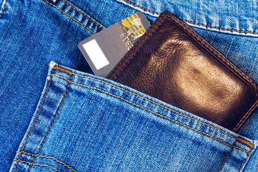 Credit card in wallet in pocket of jeans, closeup. Closeup of wallet and credit card in jeans trousers pocket. 
