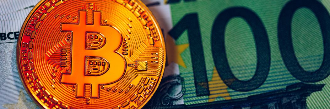 Golden bitcoin over Euro money. Bitcoin cryptocurrency. Crypto currency concept. Bitcoin with euro bills. Bitcoins stacked on euro banknotes.