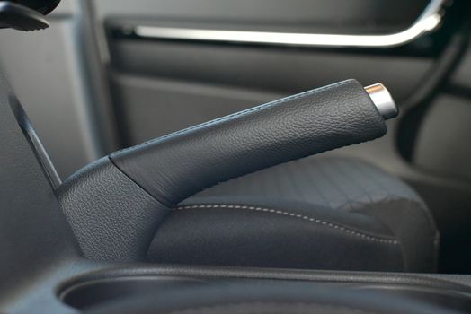 Manual brake in interior of modern car close up, Car parking brake, Close up car hand brake