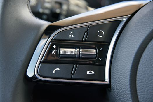 detail on the steering wheel to control cell phones, luxury accessories in a passenger car