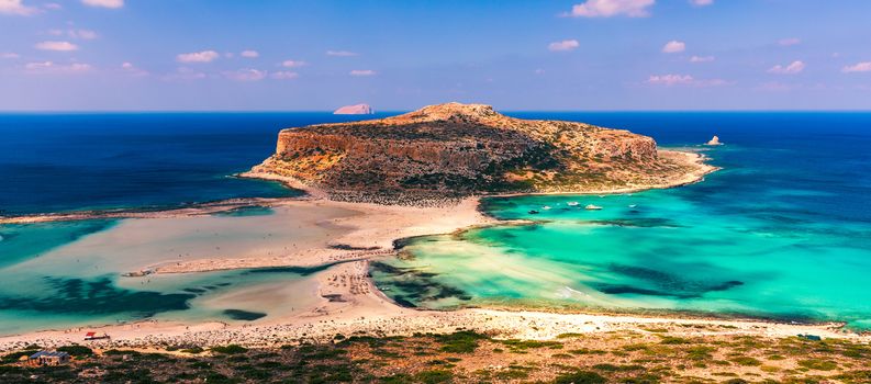 Fantastic panorama of Balos Lagoon and Gramvousa island on Crete, Greece. Cap tigani in the center. Balos beach on Crete island, Greece. Tourists relax and bath in crystal clear water of Balos beach.